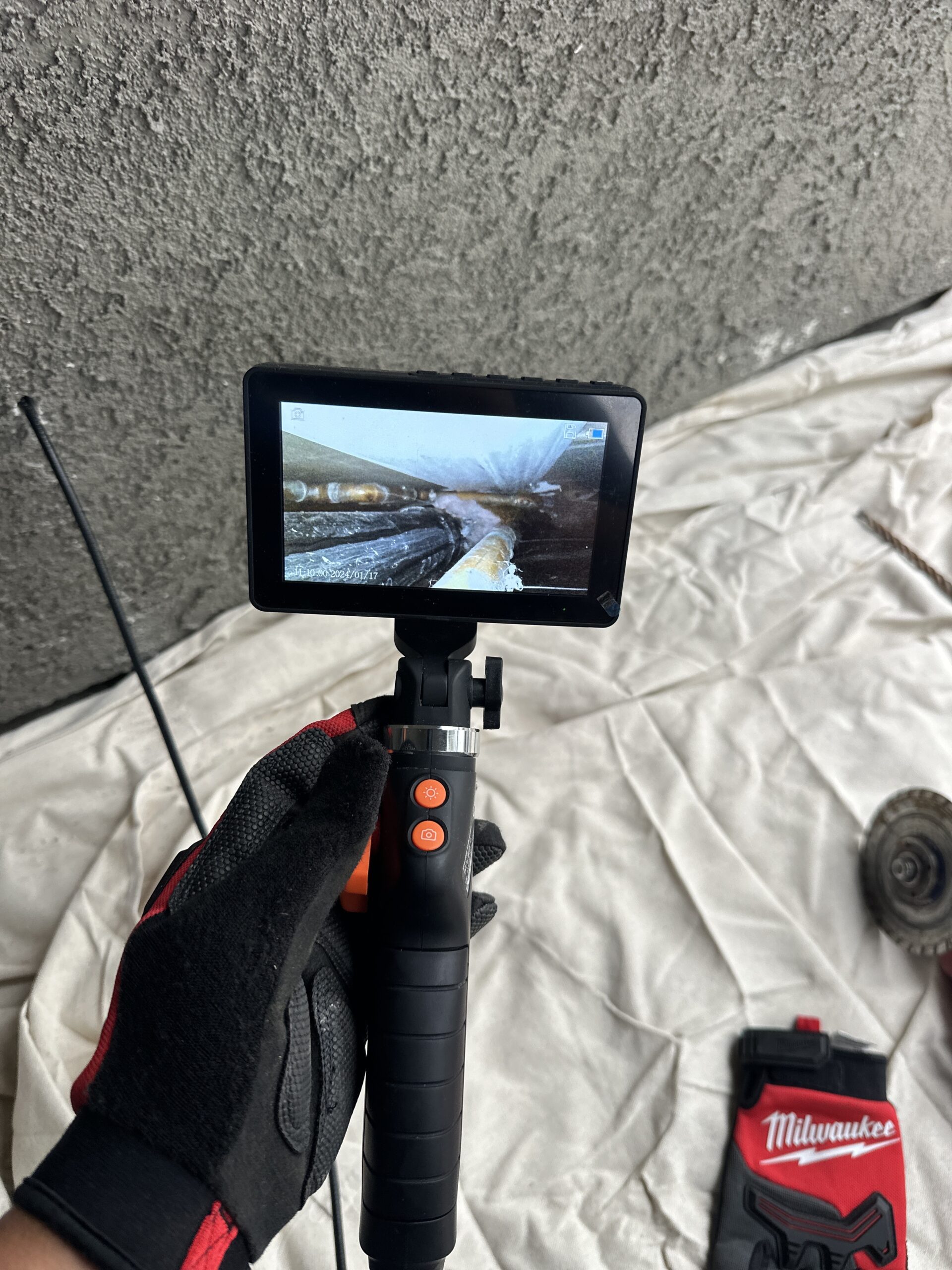 Drain leak detection being performed to locate hidden leaks in underground and in-wall drain piping.