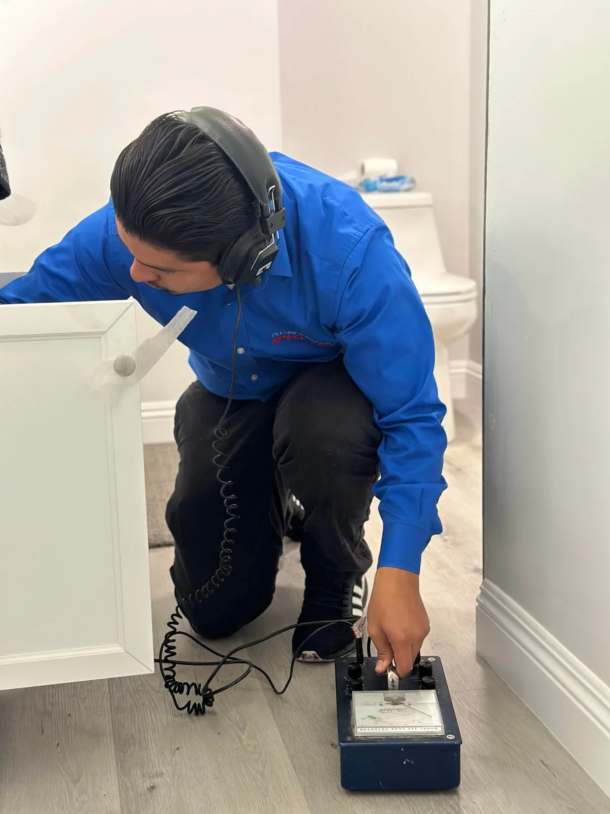 Technician performing professional water leak detection inside a home