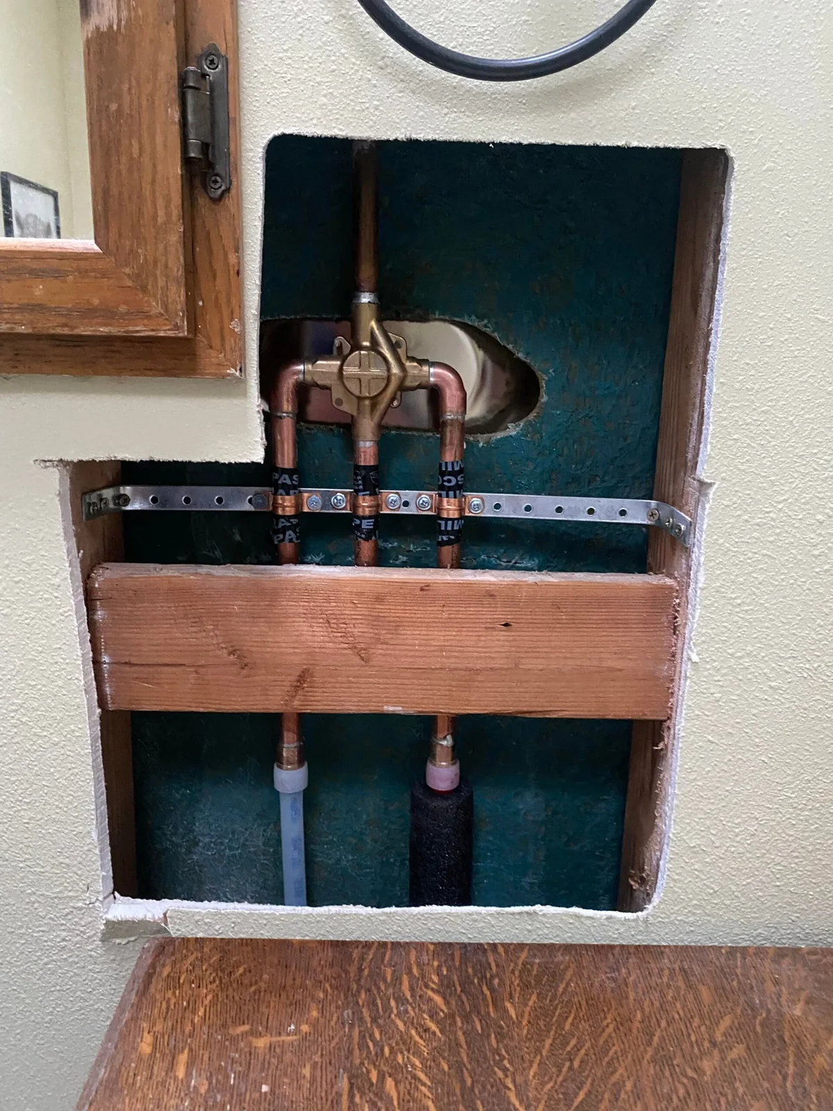 New water lines routed through an accessible wall opening