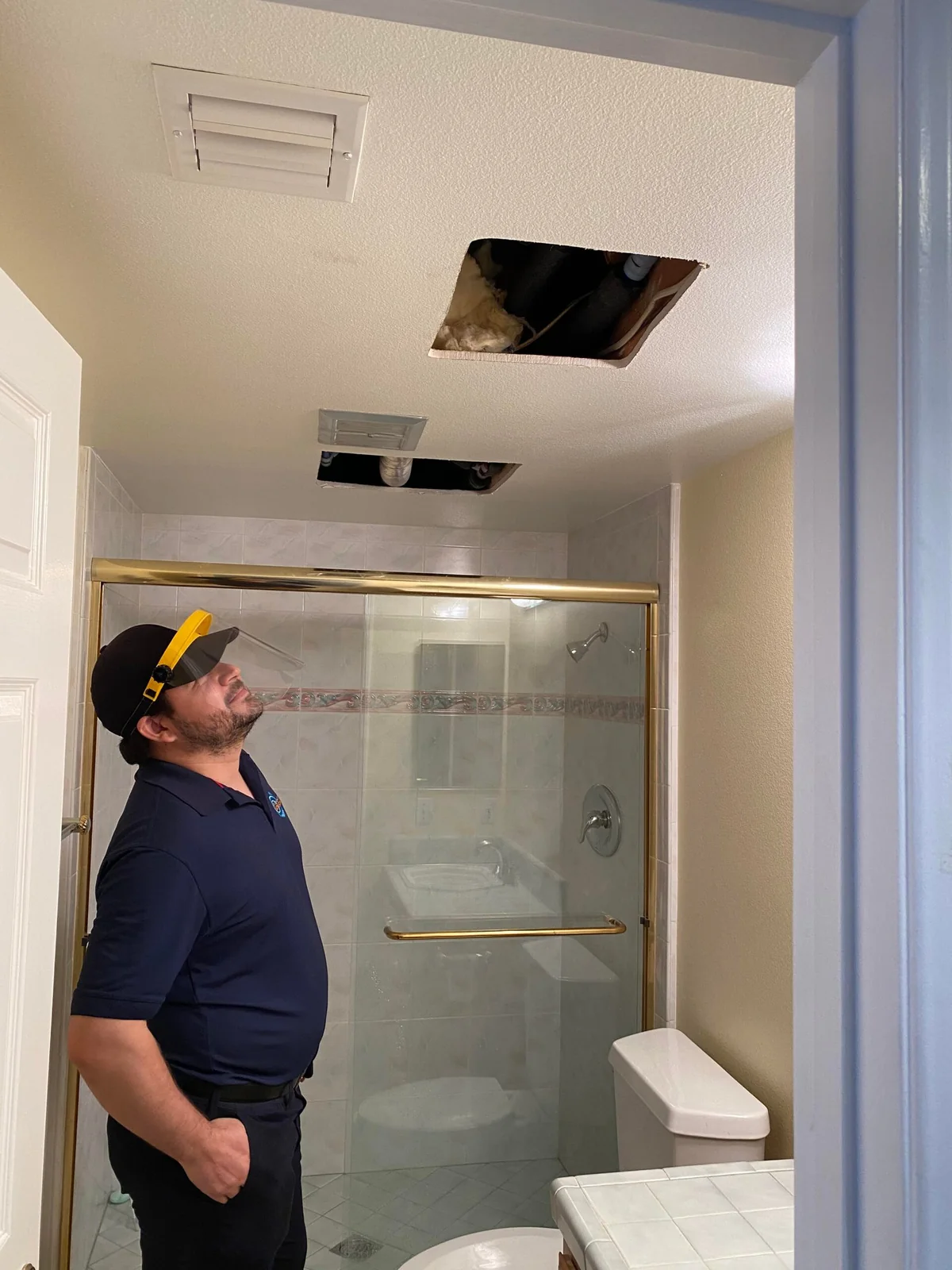 Technician inspecting completed plumbing access work