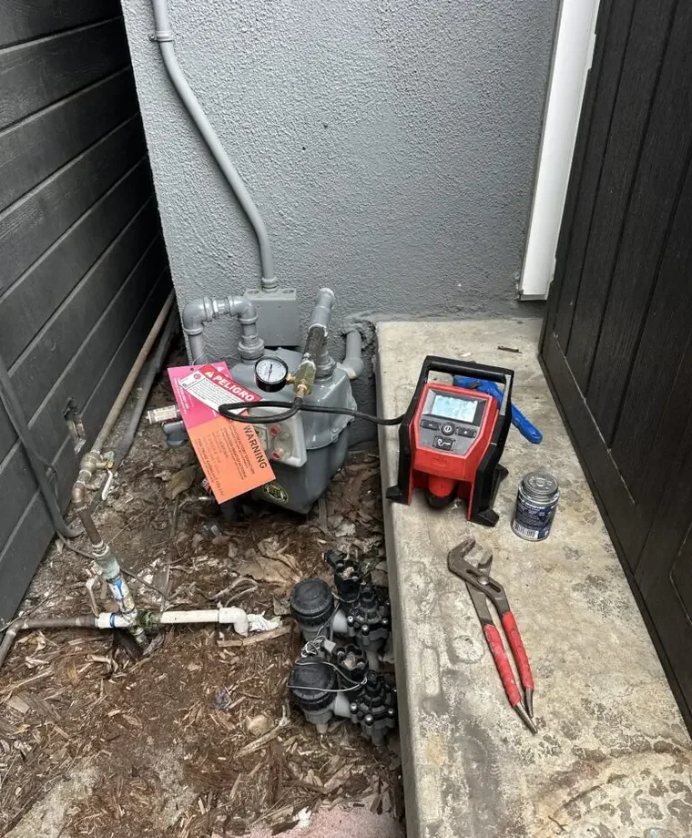 Gas meter and testing equipment used during gas leak detection