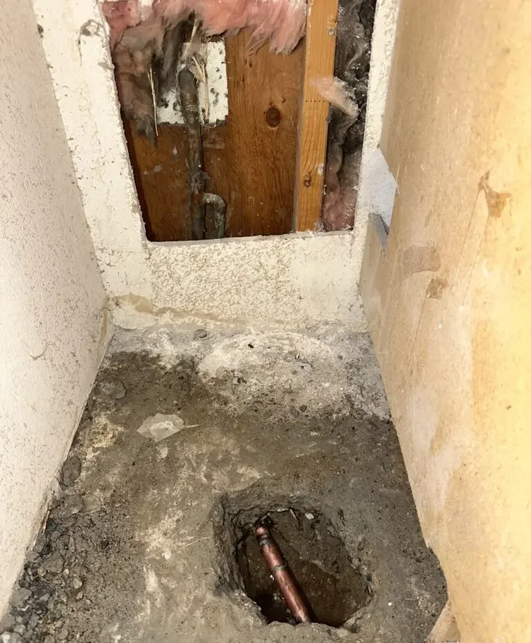 Access opening exposing a pipe for a confirmed slab leak repair