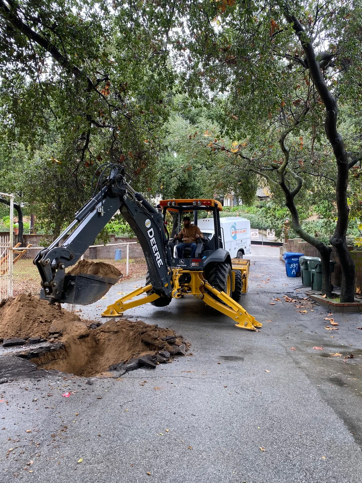 Excavation exposing a sewer line for professional repair