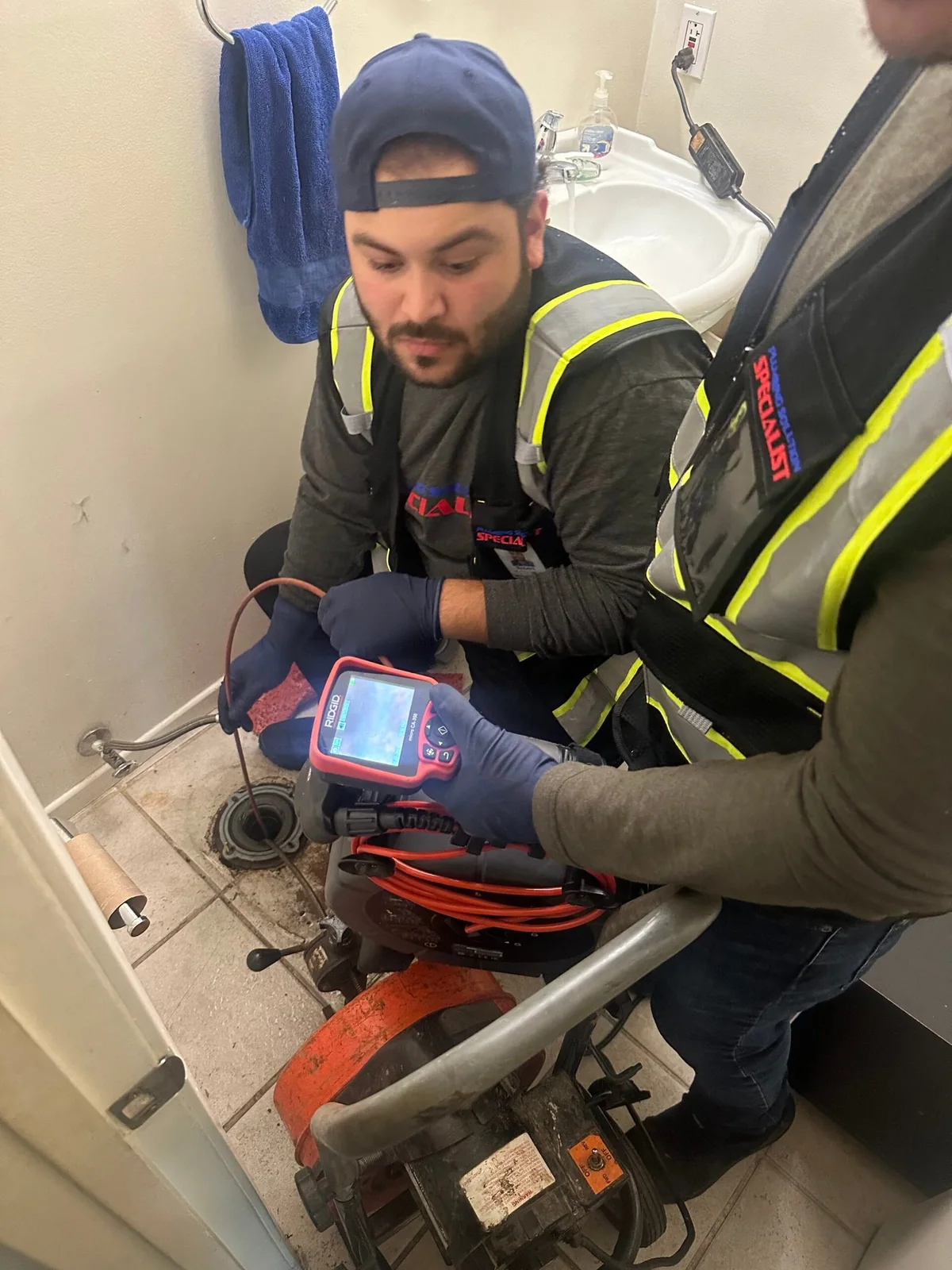 Technician using electronic equipment during slab leak detection